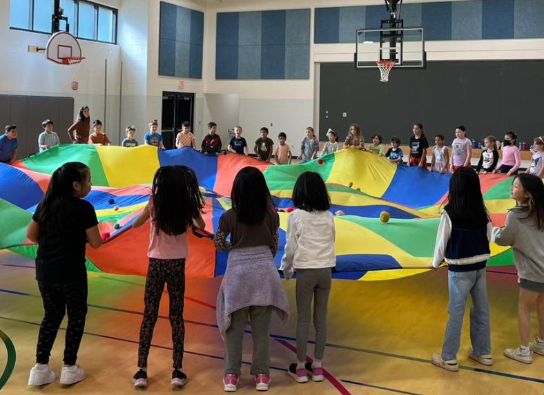 students with parachute in new gym