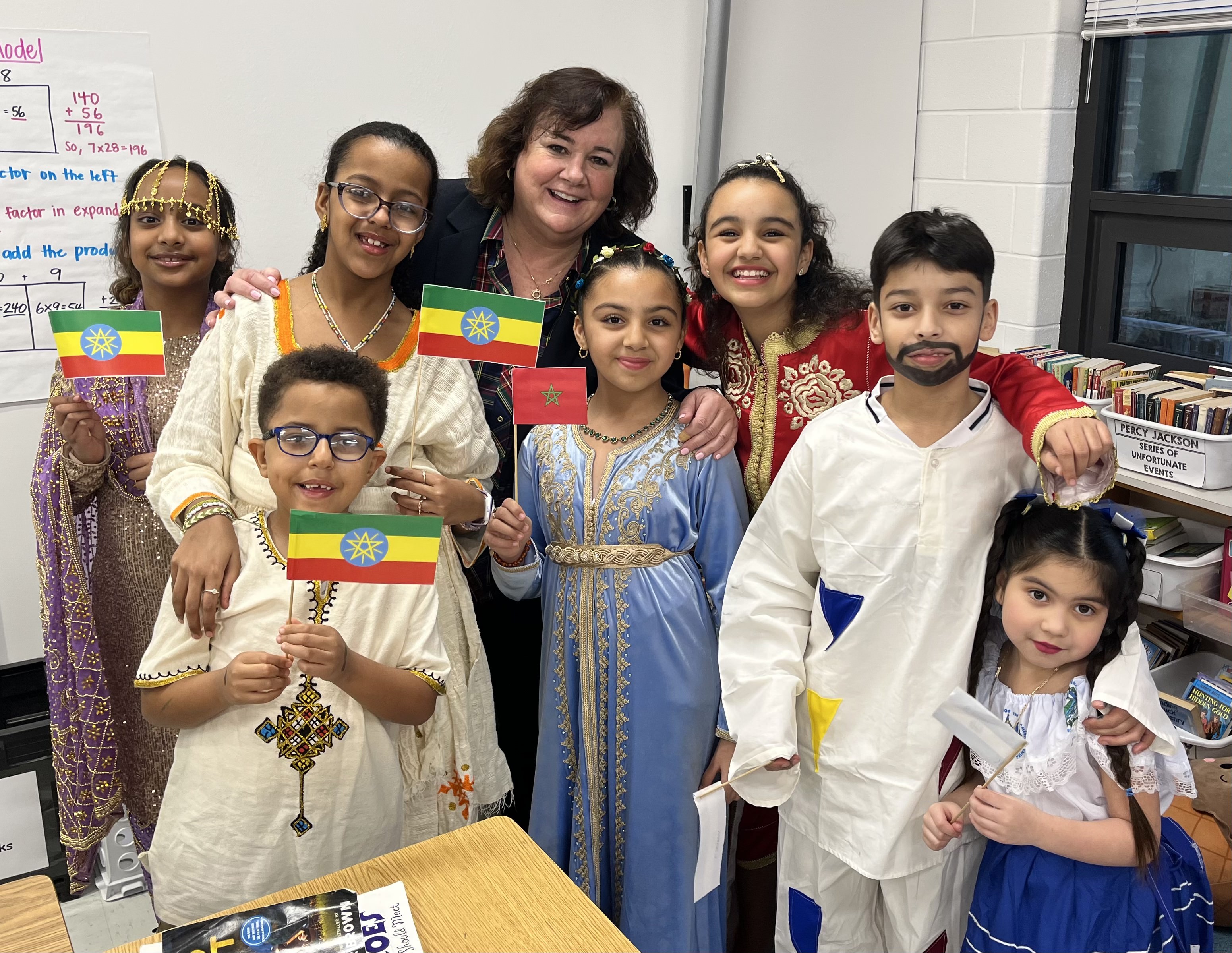 students at Family Heritage Night showing flags